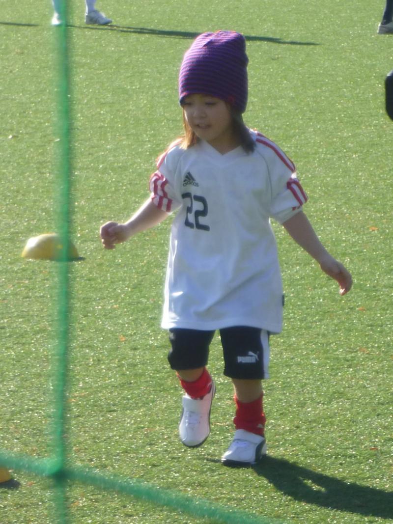 Little girls plays with football