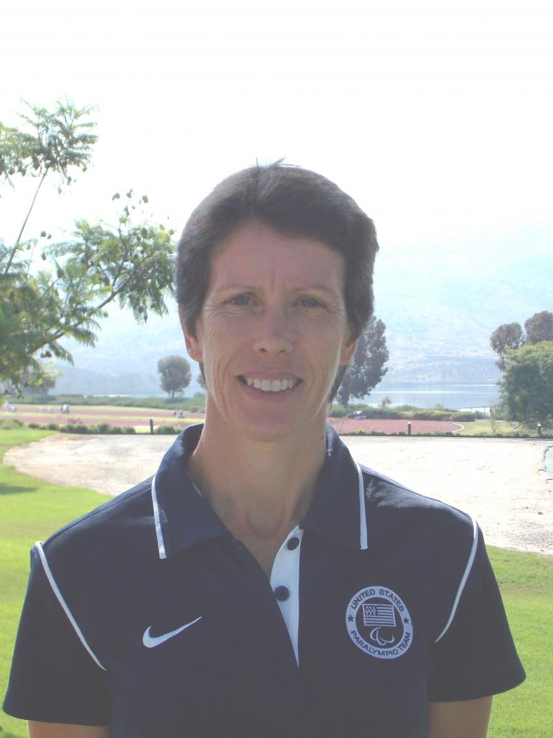 Portrait picture of a women in Team USA uniform in front of a landscape