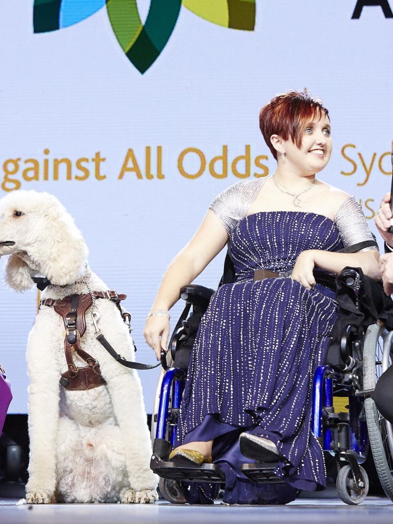 Sydney Collier and her service dog Journey receive the 2014 FEI Against All Odds award.