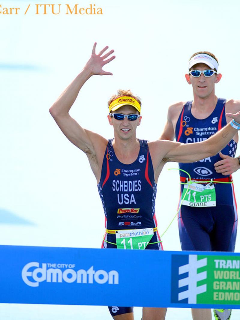Aaron Scheidies crosses the finish line with his guide at a race in Edmonton.