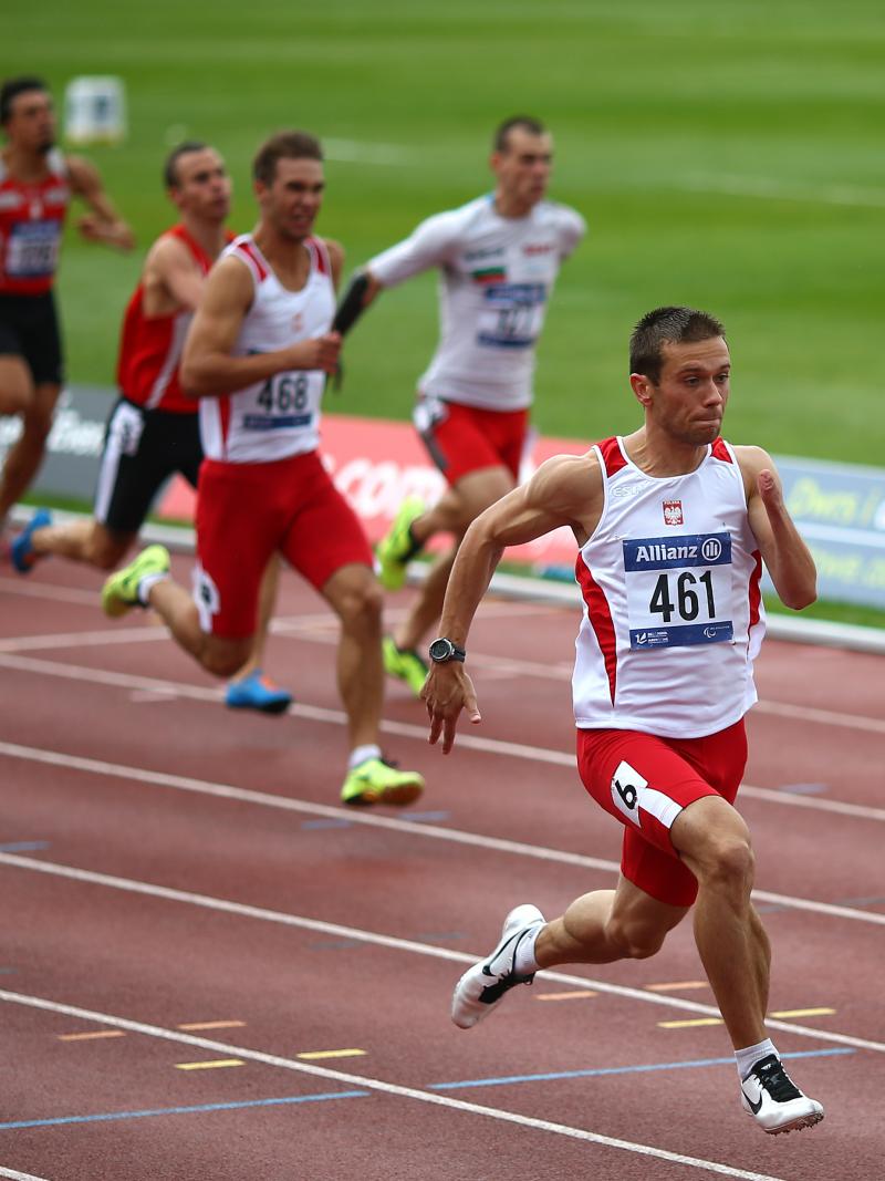 Group of men sprinting on a track