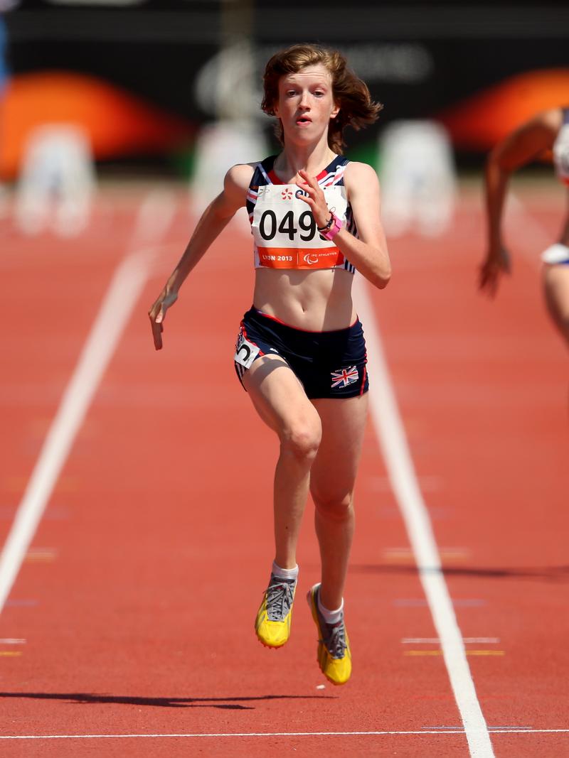 Women run on the finish line of a stadium