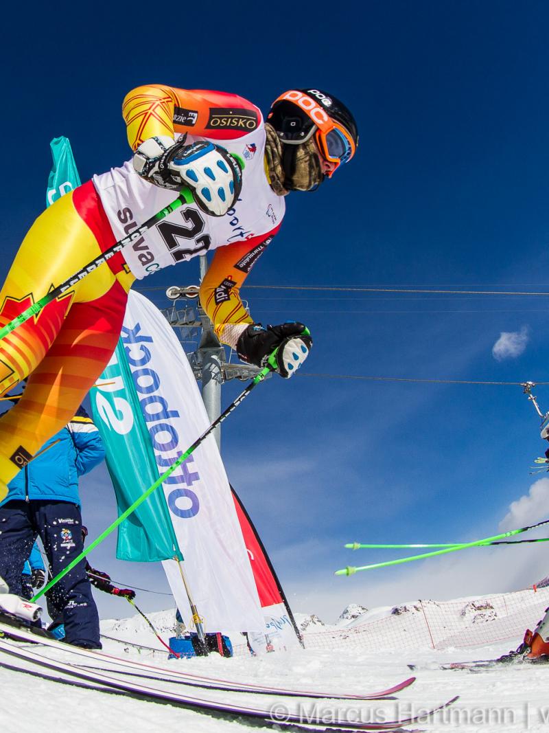 Two skiers starting from a start house on a ski slope