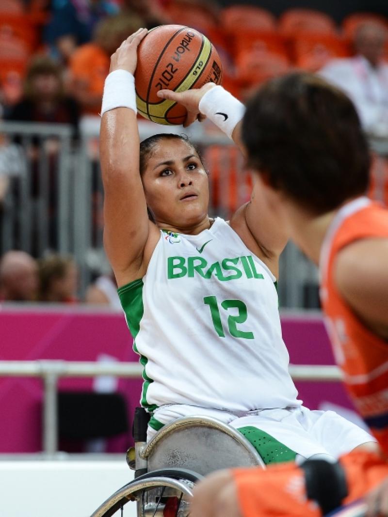 women in wheelchair saves the basketball