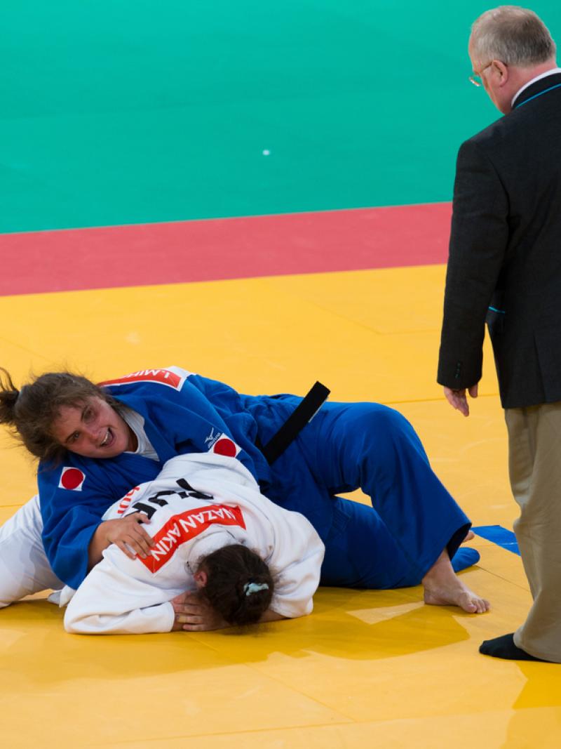 Two women on the floor, practising judo