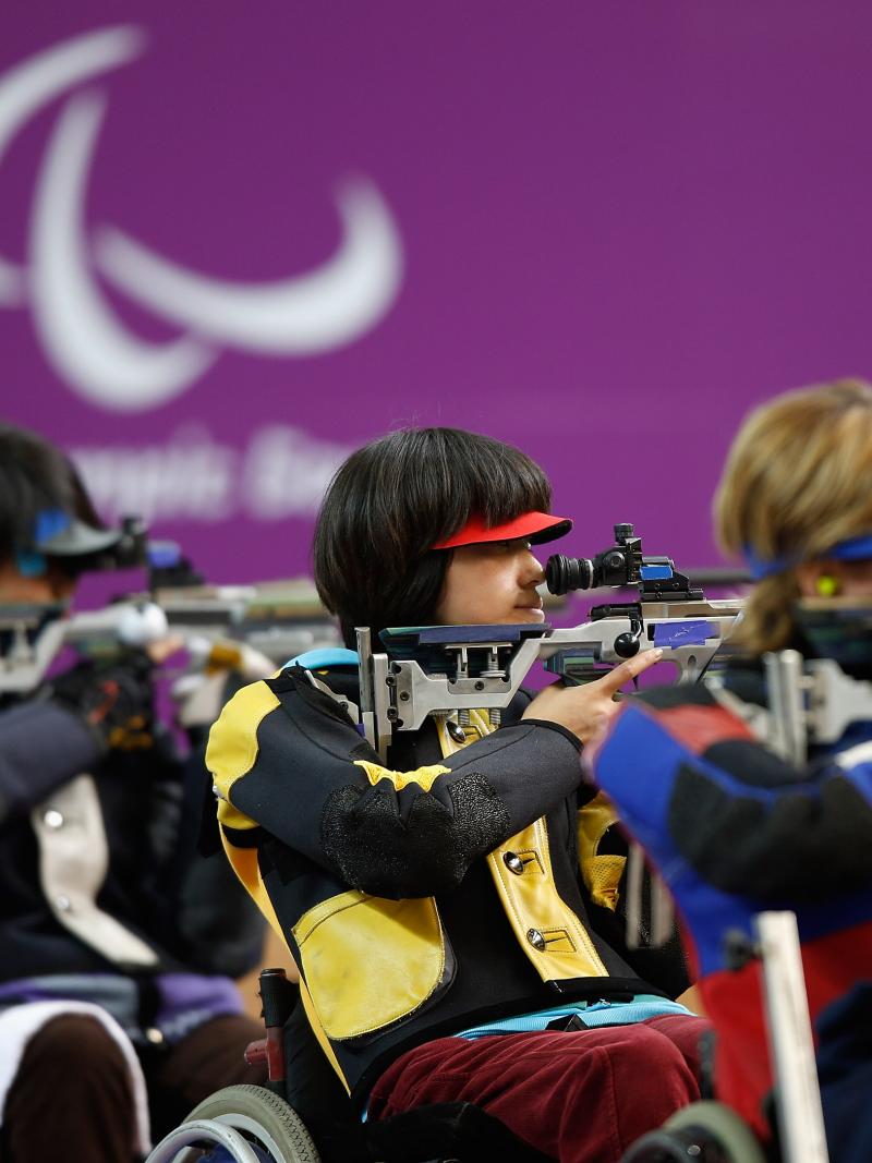Yoojeong Lee of the Republic of Korea (R) shoots during the Women's R8-50m Rifle 3 Positions-SH1 final at the London 2012 Paralympic Games