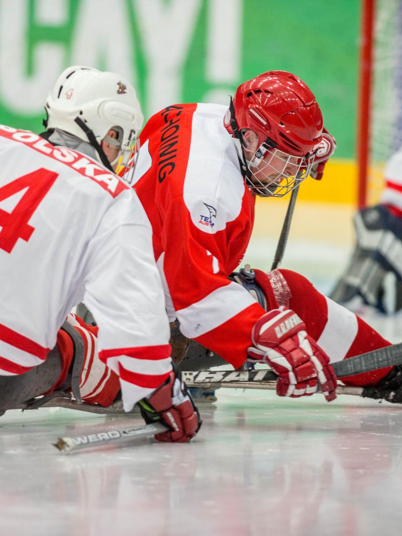 Sylwester Flis, Poland, and Martin Pachoinig, Austria, fighting for the puck in the preliminary game at the 2015 IPC Ice Sledge Hockey World Championships B-Pool in Ostersund, Sweden.