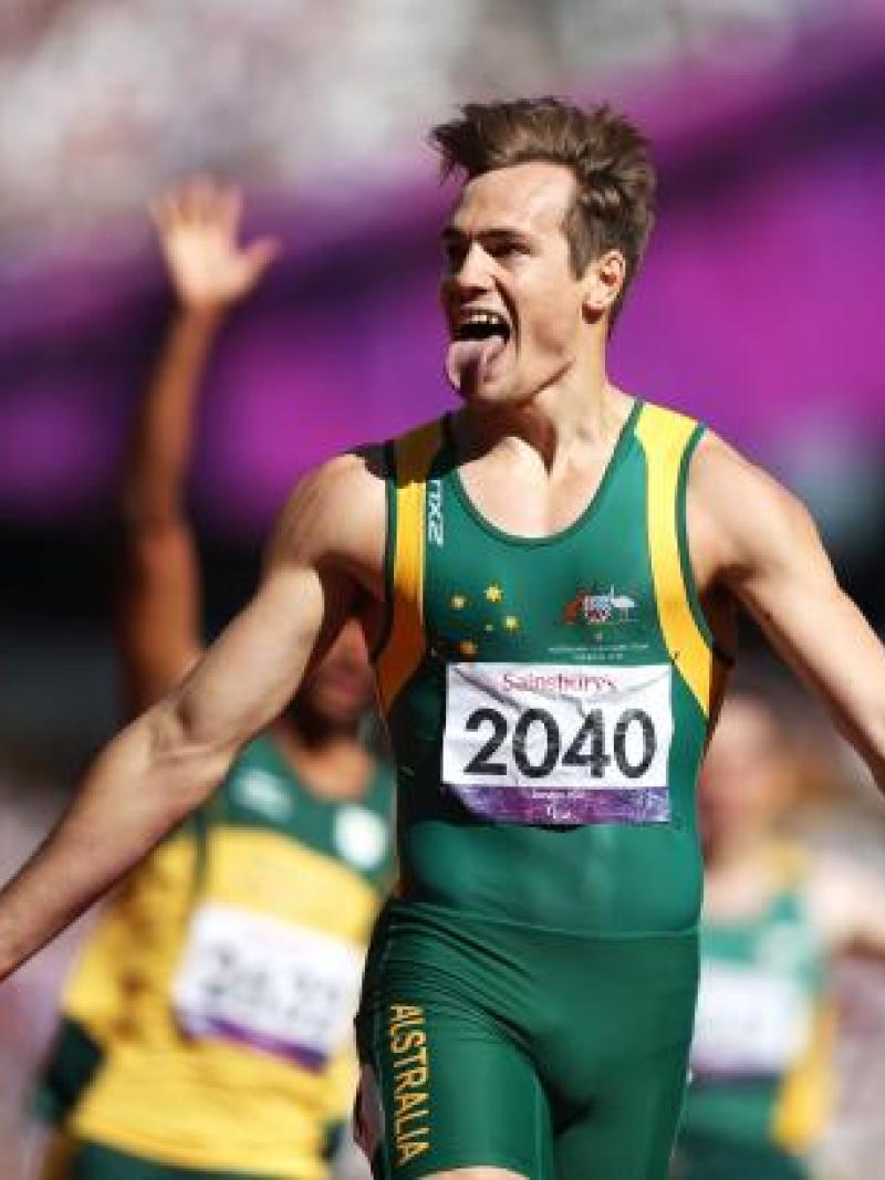 A picture of a man celebrates the victory after crossing the line