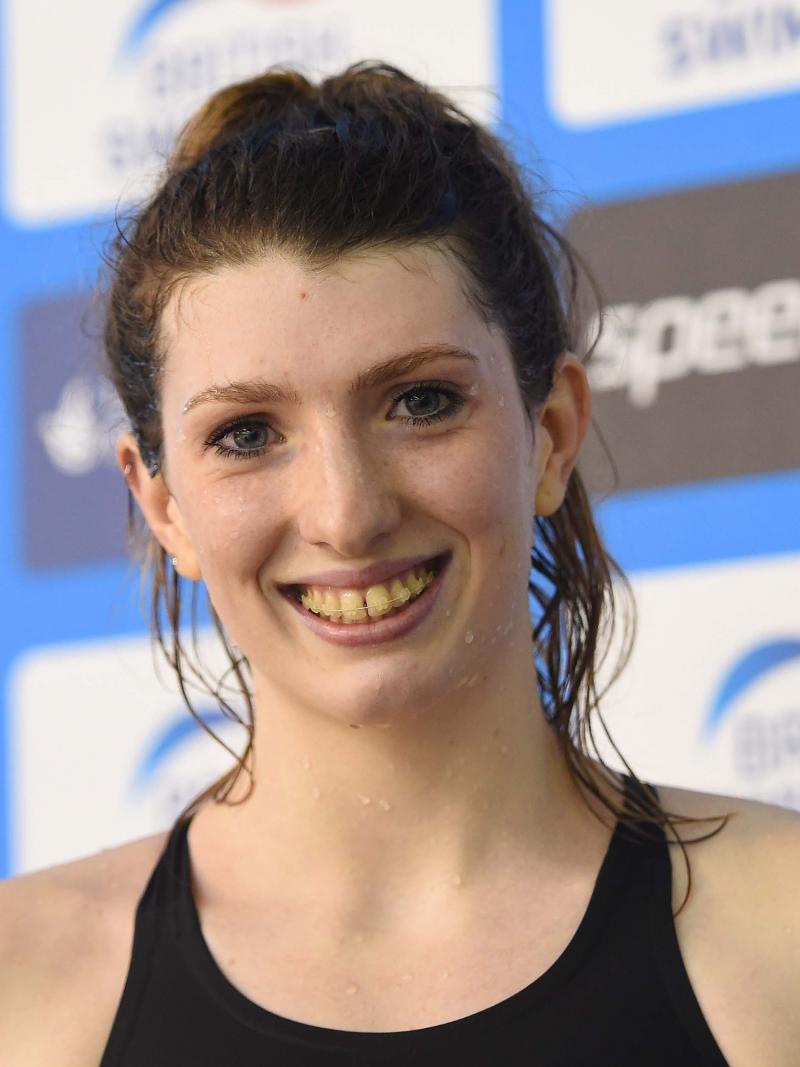 A swimmer smiles having won gold and set a new world record