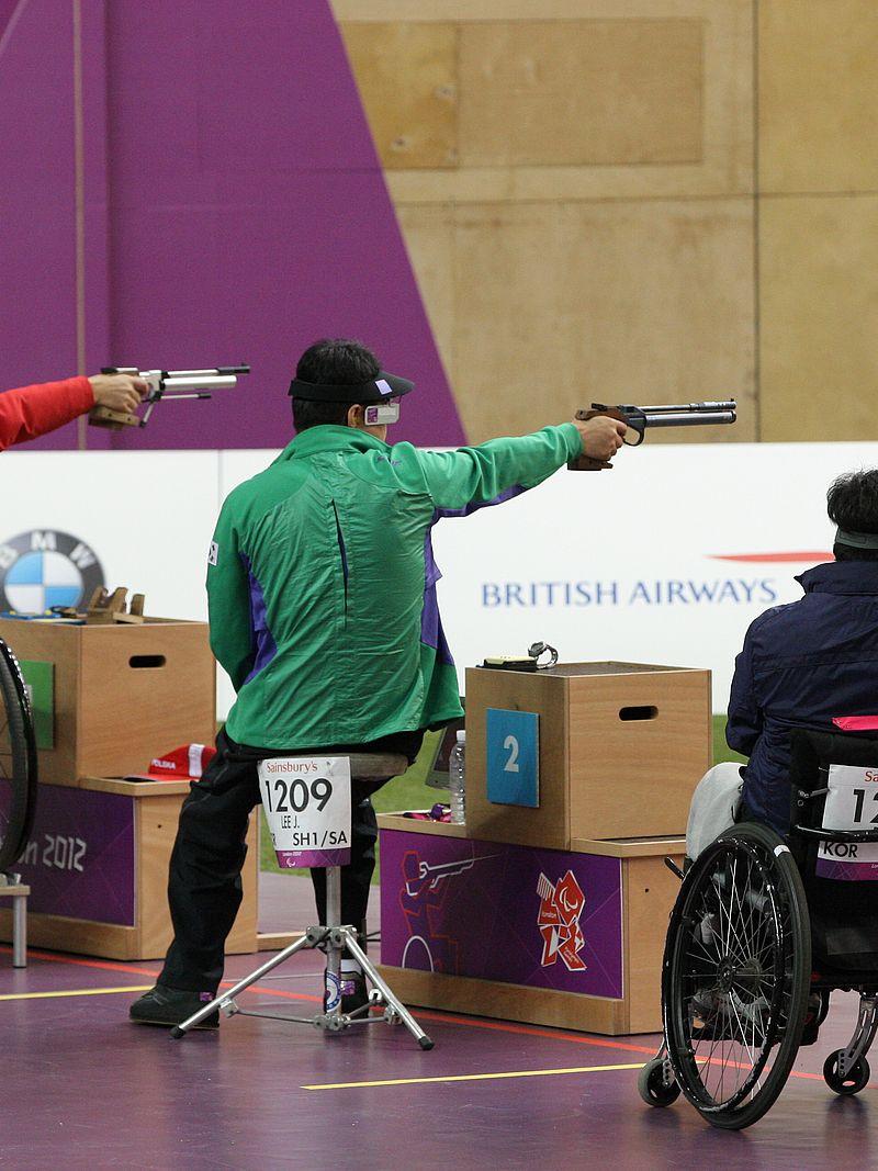 Three athletes shooting in a range