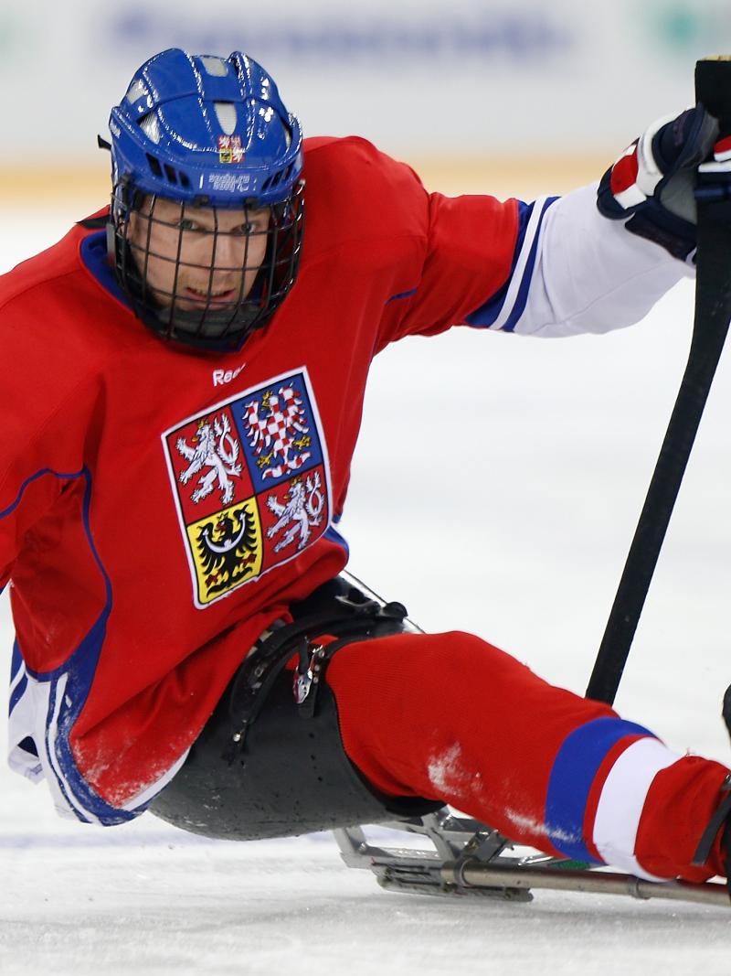 Man on hockey sledge focusing on the puk