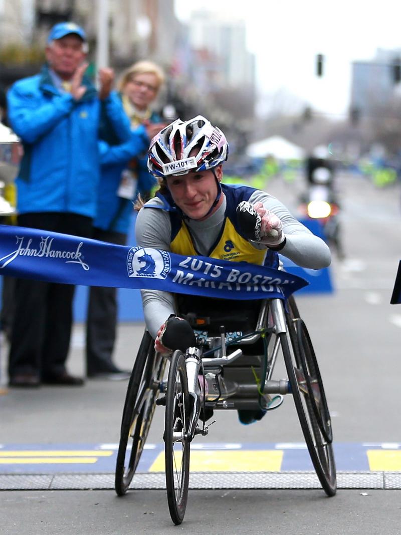 Tatyana McFadden of the United States crosses the finish line to win the women's push rim wheelchair division of the 119th Boston Marathon on April 20, 2015 in Boston, Massachusetts.