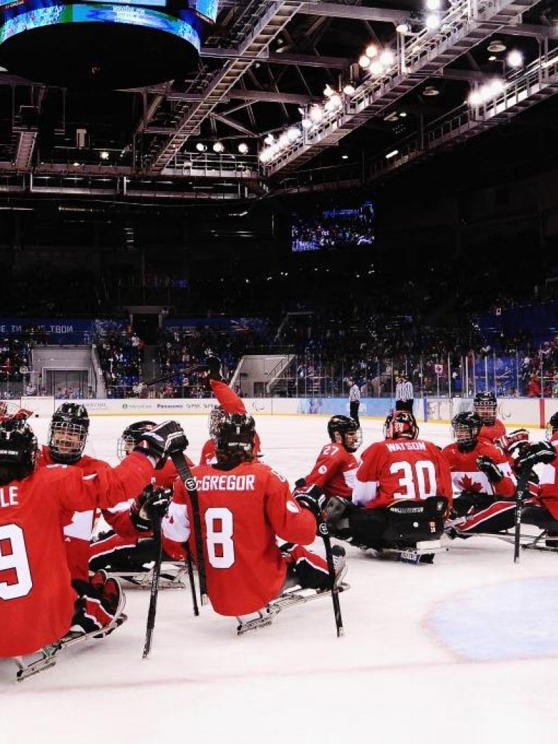 Canada players celebrate after the ice sledge hockey bronze medal game between Canada and Norway at the Shayba Arena at the 2014 Paralympic Winter Games.