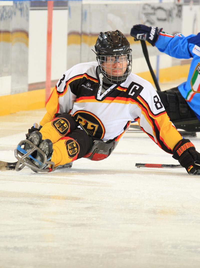 Man on ice sledge hockey makes a turn