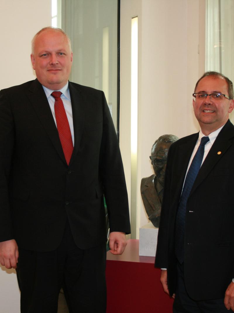 A picture of two men standing side by side.