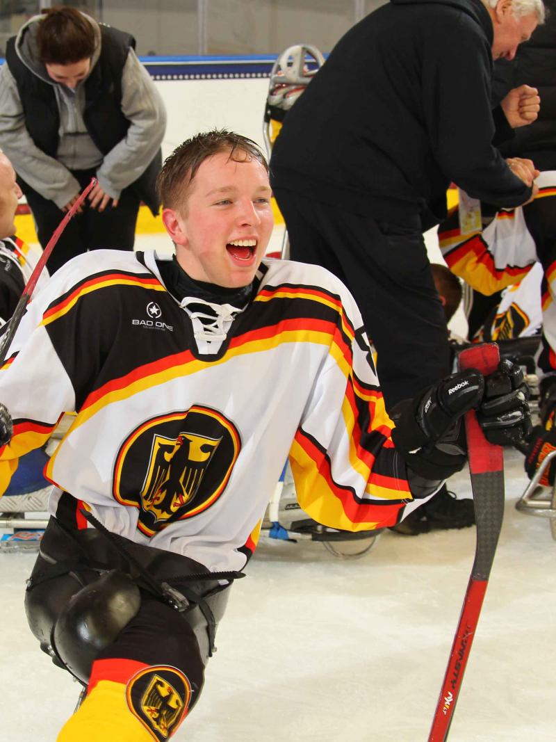German sledge hockey player cheering.