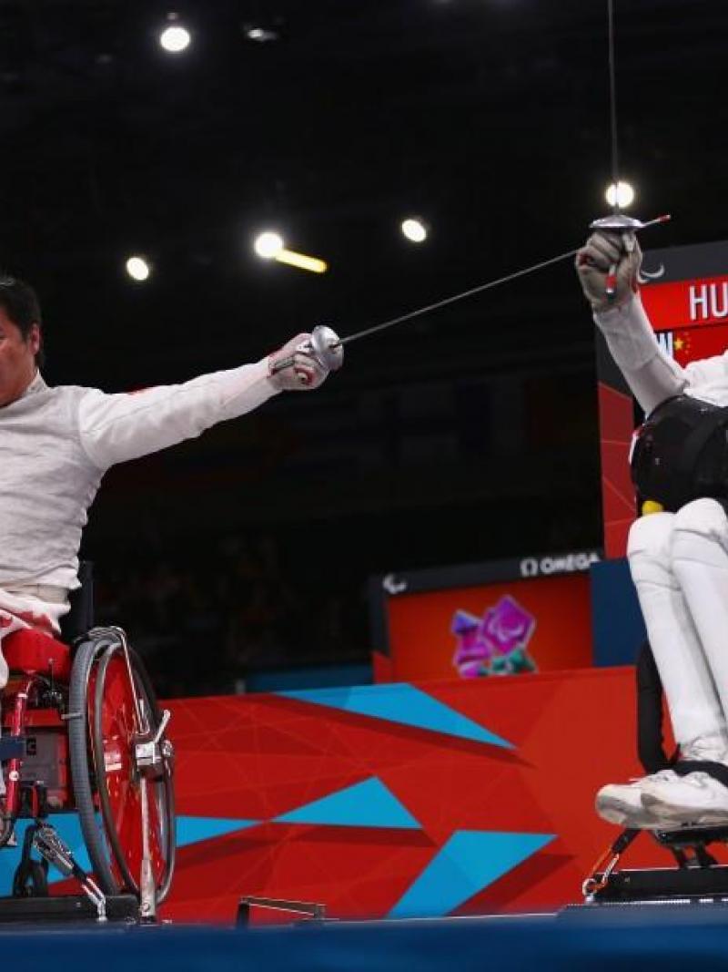 Daoliang Hu (L) of China celebrates winning gold against Anton Datsko (R) of Ukraine during the Men's Individual Foil Category B final of the Wheelchair Fencing on day 6 of the London 2012 Paralympic Games.