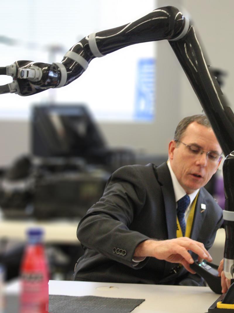 Man working with a robot arm