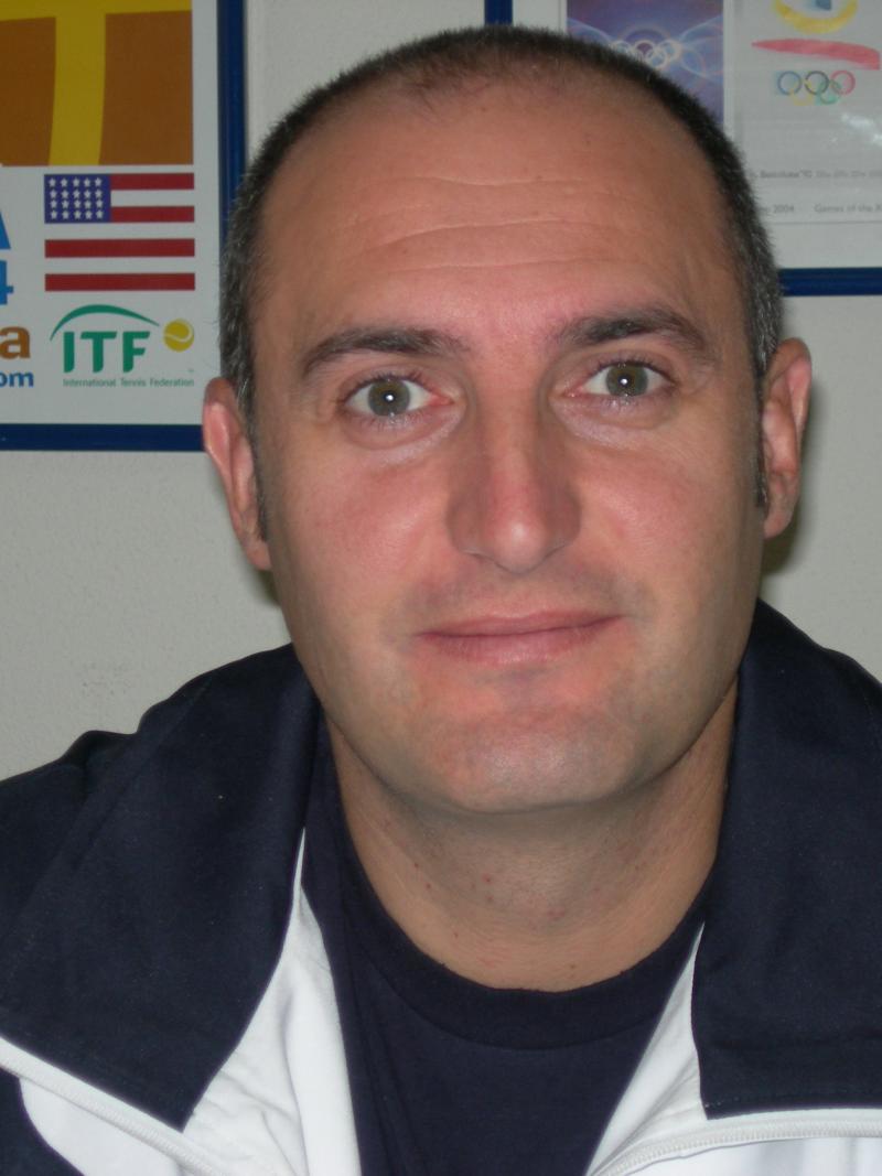 Portrait photo of a dark haired man