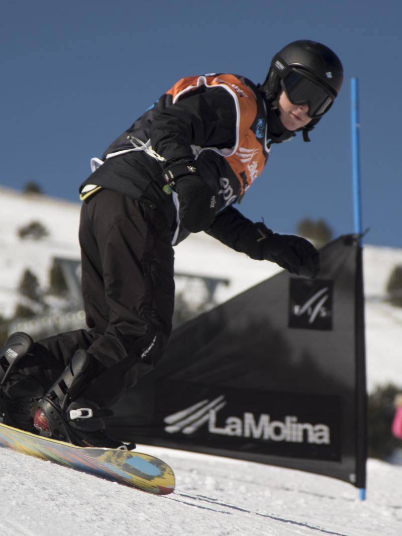 Snowboarder passing a gate