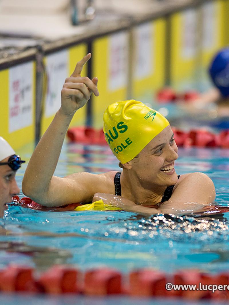 A swimmer celebrates a race win and world record