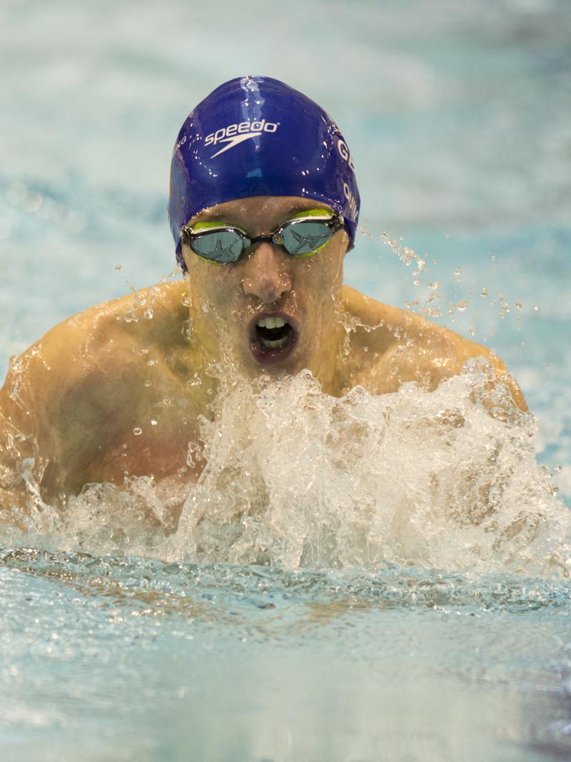 A Para swimmer competes in breaststroke