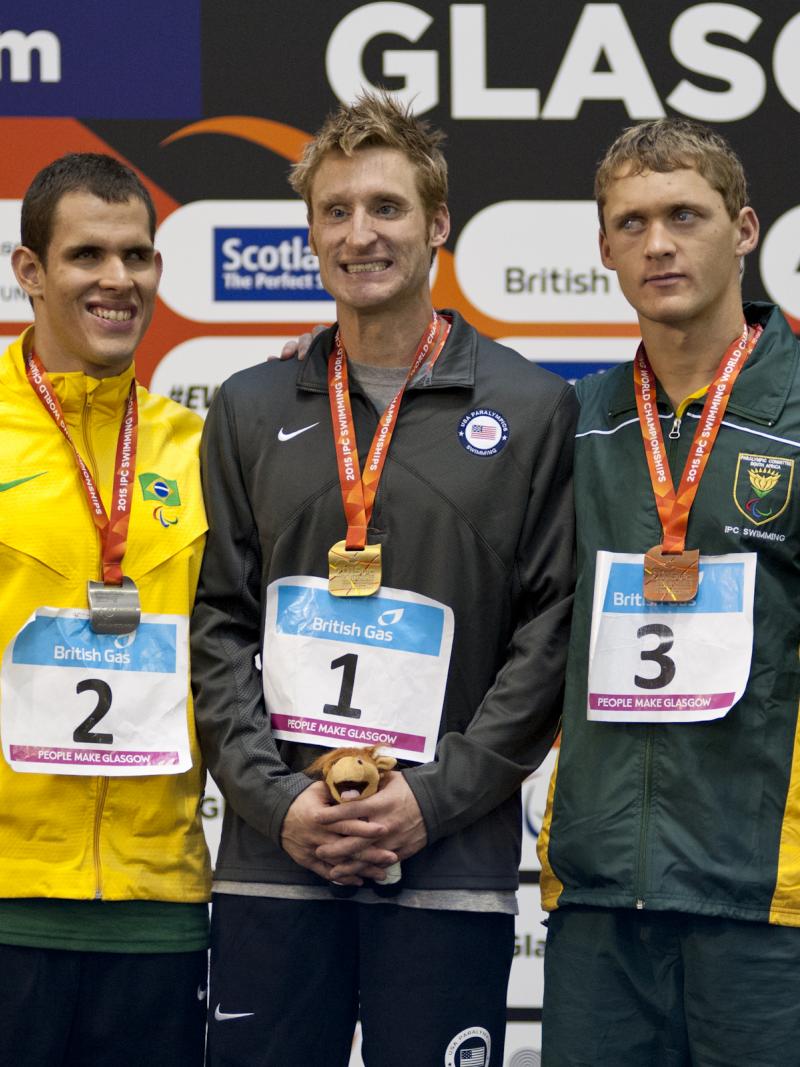 Bradley Snyder, Matheus Sousa and Hendri Herbst on the podium after the Men's 100m Freestyle S11 at the 2015 IPC Swimming World Championships in Glasgow.