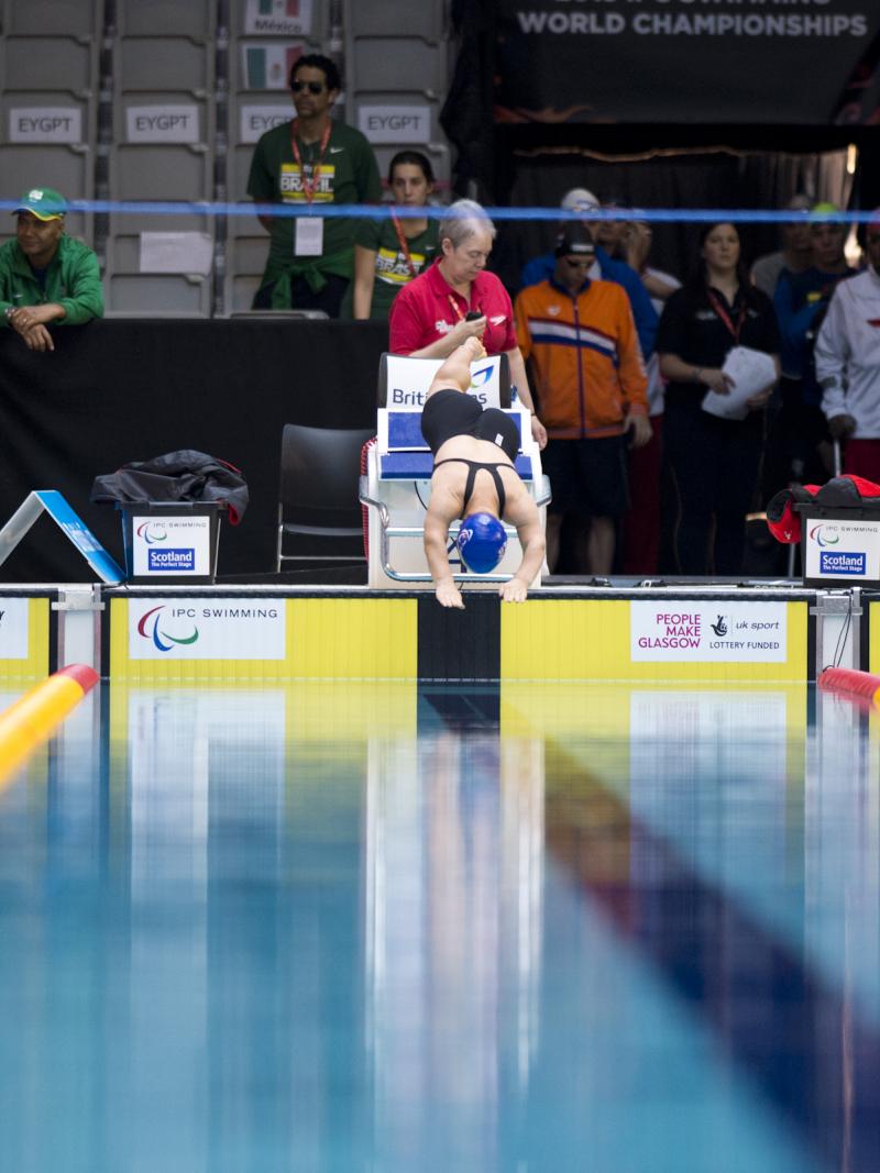 Three women jumping from a starting block