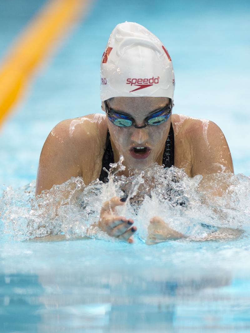 Woman in the pool swimming breaststroke