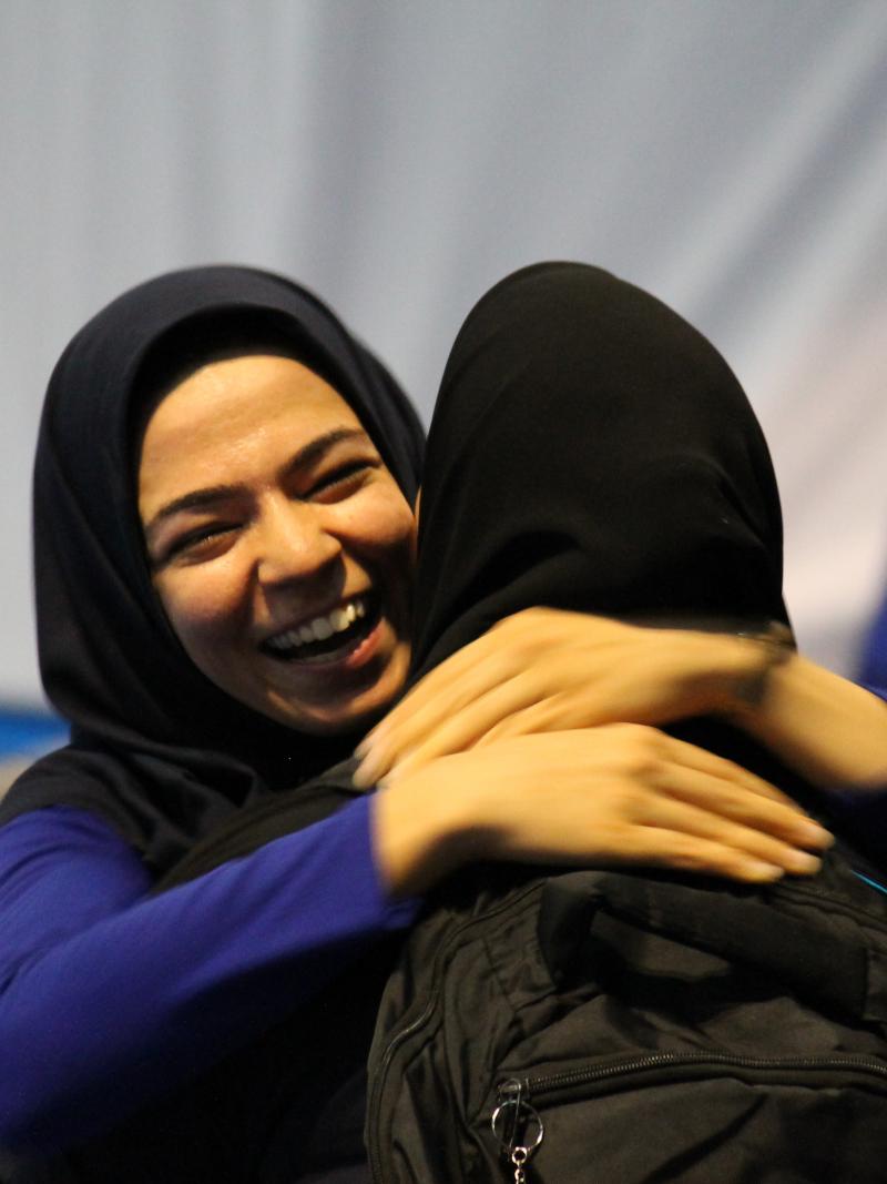 Two smiling women hugging