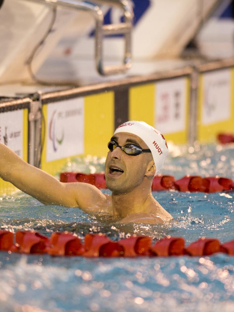 Two men in a swimming pool, after a race