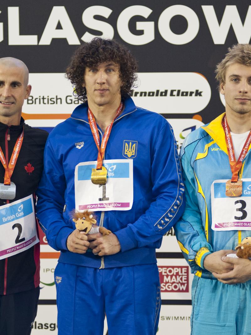 Three men on a podium