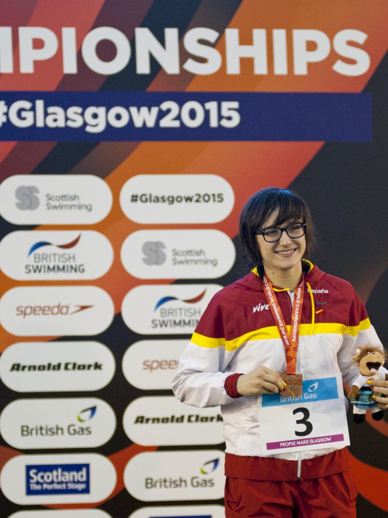 Maria Delgado Nadal of Spain on the podium after the women's 100m backstroke S12 at the 2015 IPC Swimming World Championships in Glasgow.