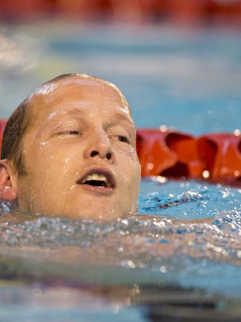 A swimmer celebrates winning a medal
