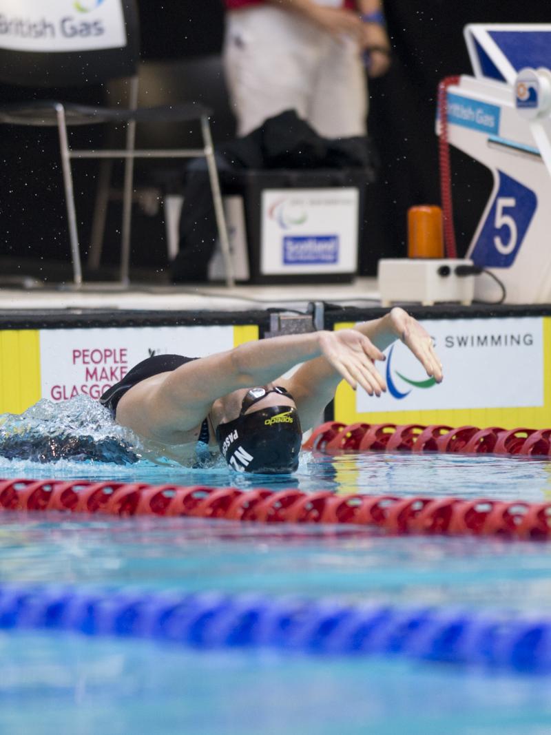 Swimmer makes a backstroke start.