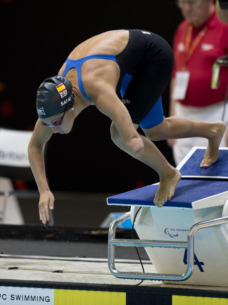 A swimmer starts their race