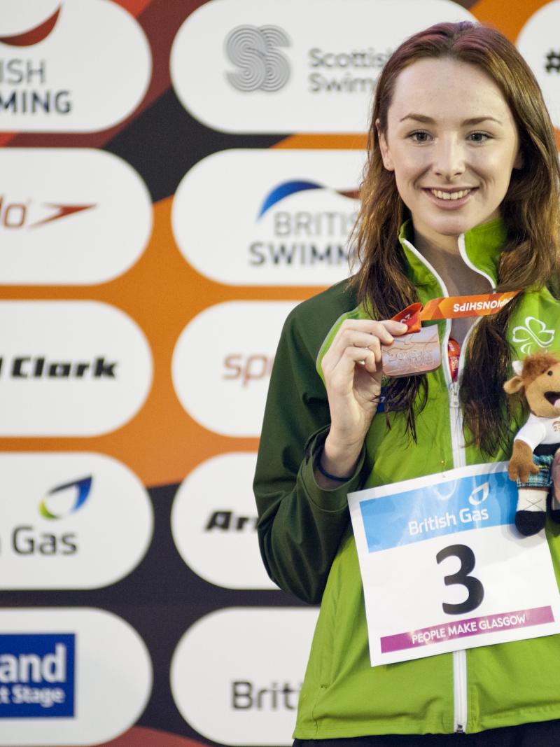 A para-swimmer celebrates winning a medal