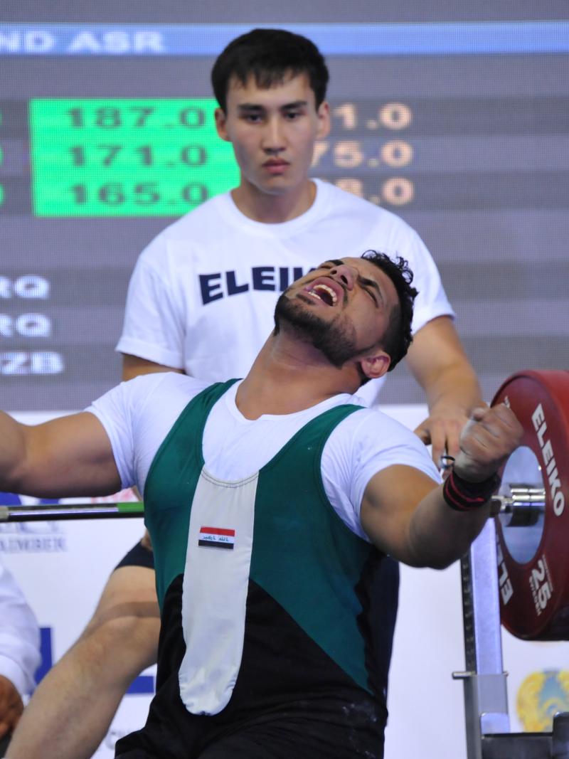 Man sitting on bench, celebrating