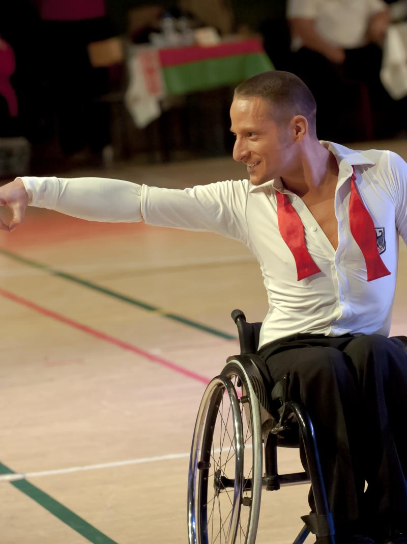 Man in wheelchair doing a dancing pose