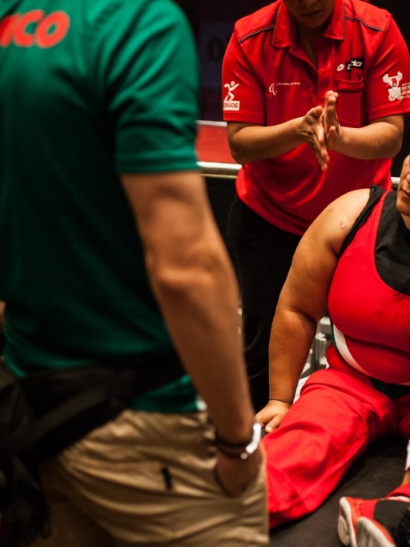 Woman sitting on a bench, preparing for her competition