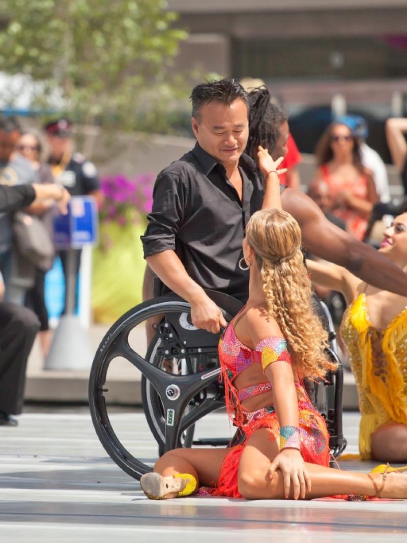 Group of dancers (wheelchairs and standing) on a stage performing