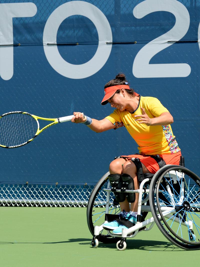 Wheelchair tennis player hitting a ball