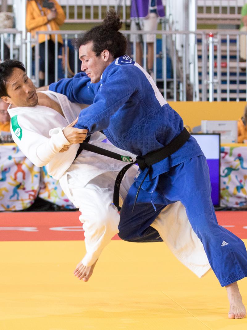 Luis Perez Diaz of Puerto Rico, fighting against Robert Kim of USA in the men's -66kg judo at the Toronto 2015 Parapan American Games.