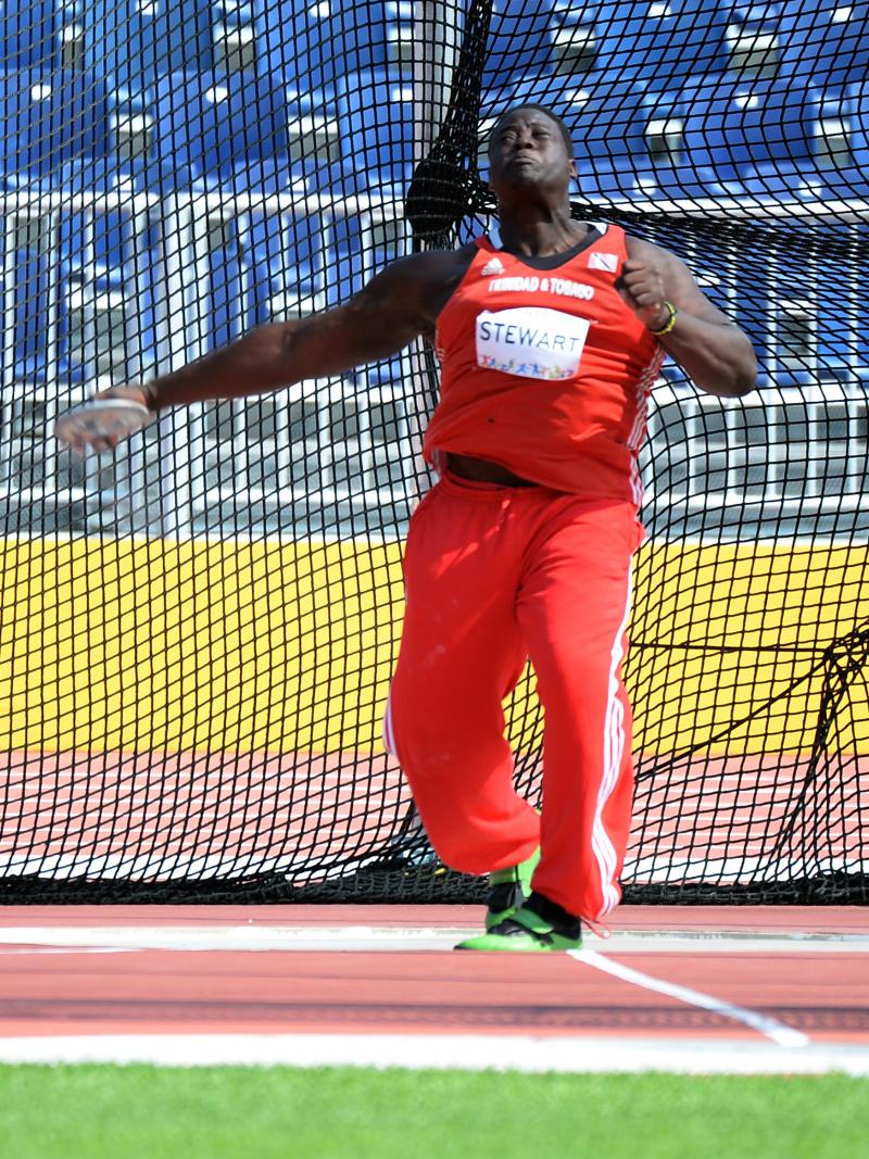 Man in red jersey throwing a discus