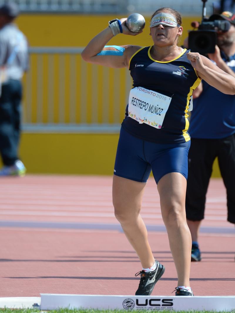 Blindfolded man throwing a shot put