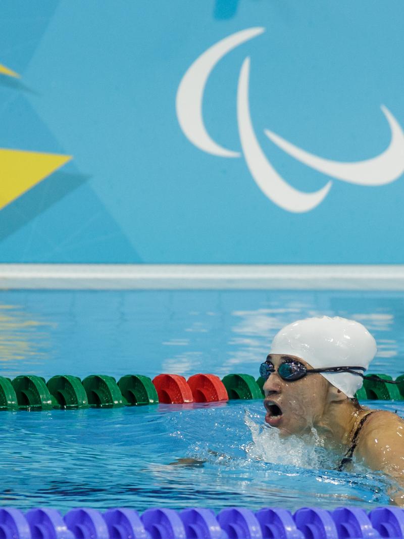 Action shot of Ilena Rodriguez swimming. Her head is just above water