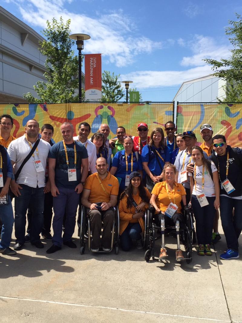 Group photo of people standing and in wheelchairs