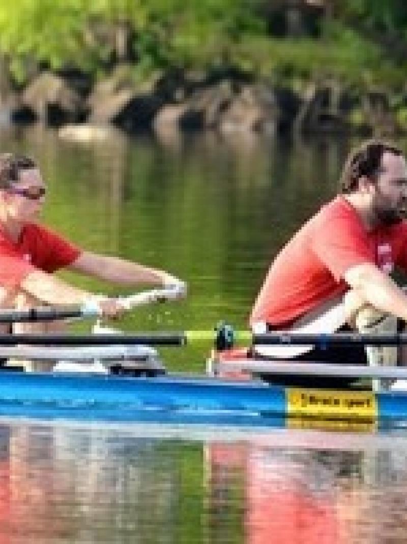 Man and woman in a boat, rowing