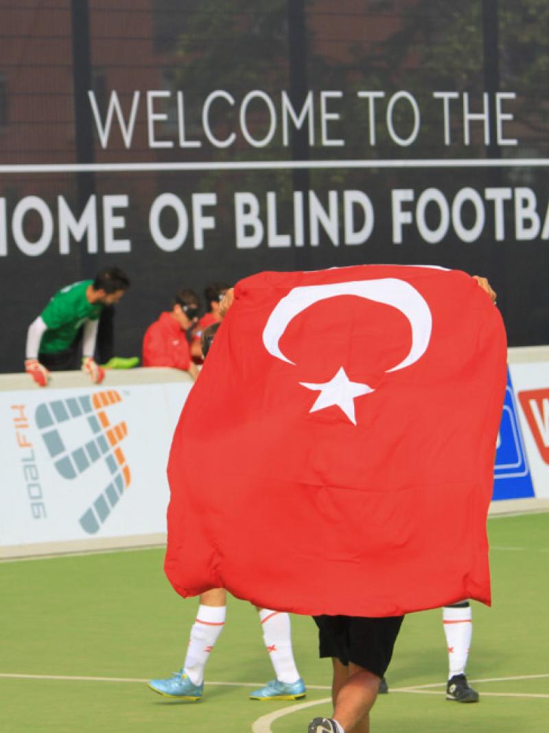 A group of blind football players celebrate a win