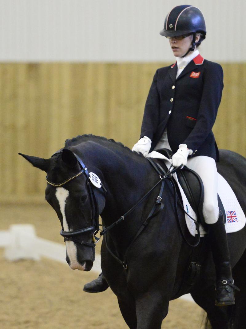 Woman riding a black horse